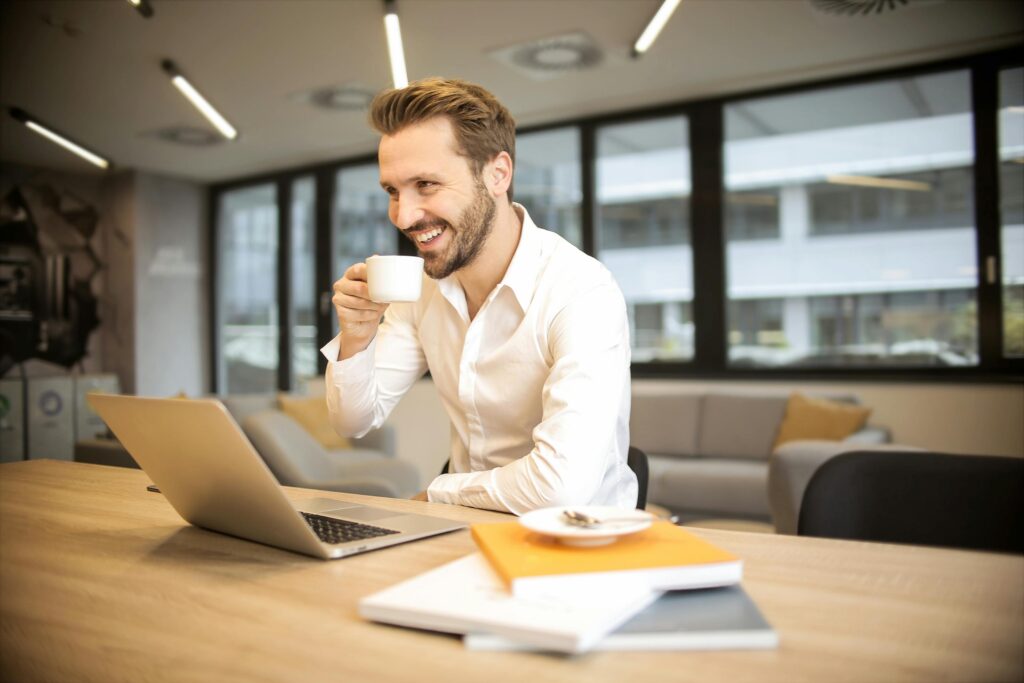 Man smiling at laptop