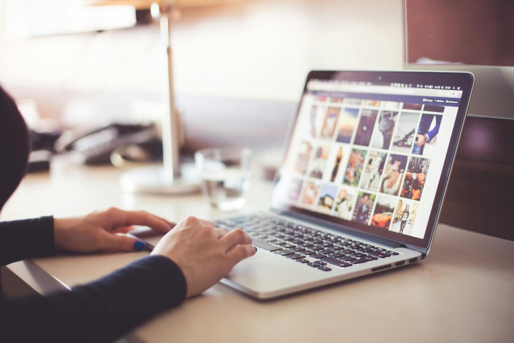 A person using social media apps on laptop